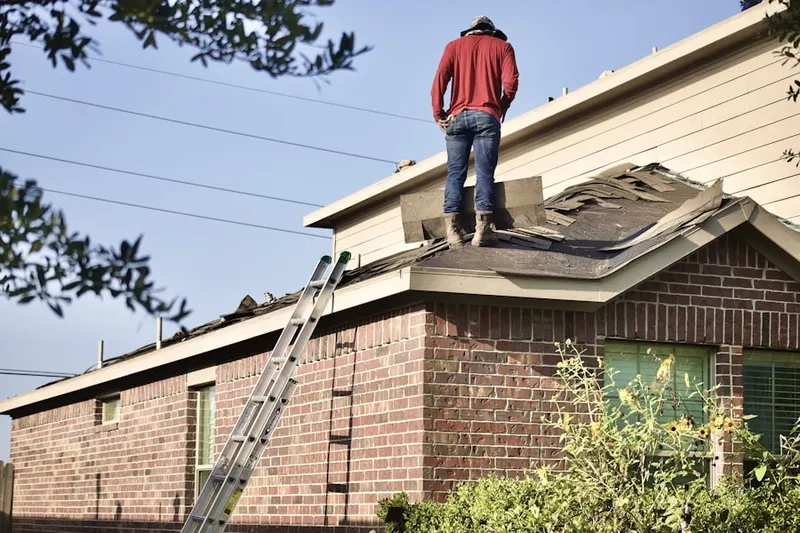 Professional roofer working on a residential roof in Ai